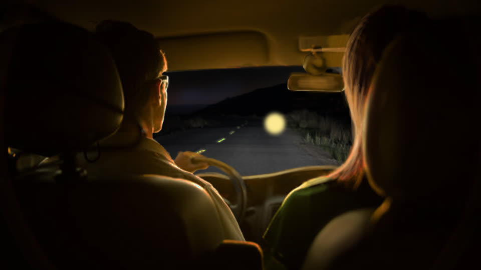 Rendering of people in a car watching an object on a road.