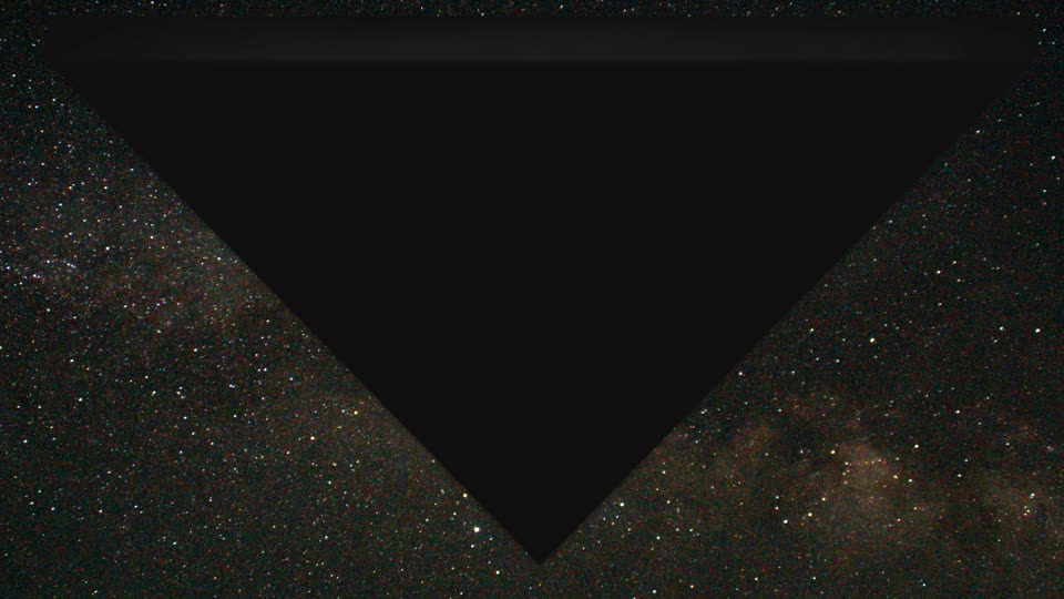 A digital rendering of a large, dark triangle against a starry night sky.