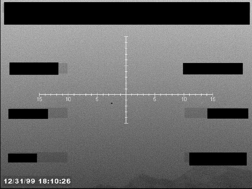 Redacted sensor image with a targeting reticle.