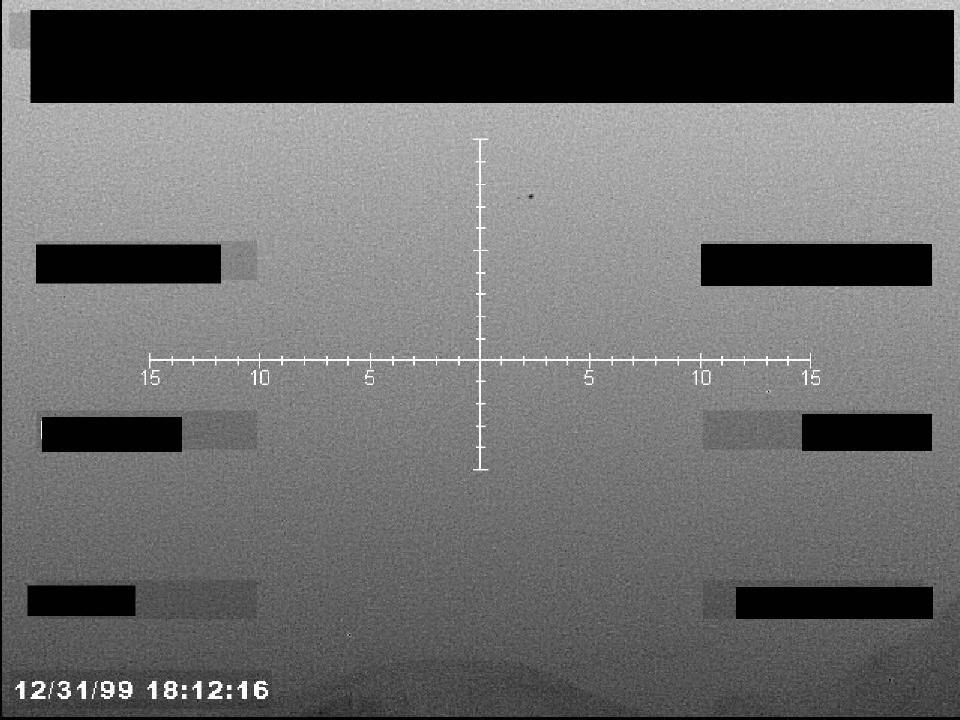 Redacted sensor image with a targeting reticle.