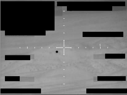 Redacted sensor image with a crosshair targeting an object.
