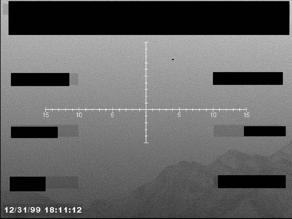Redacted sensor image with a targeting reticle.