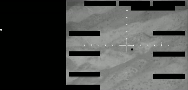 Redacted sensor image with a crosshair targeting an object.