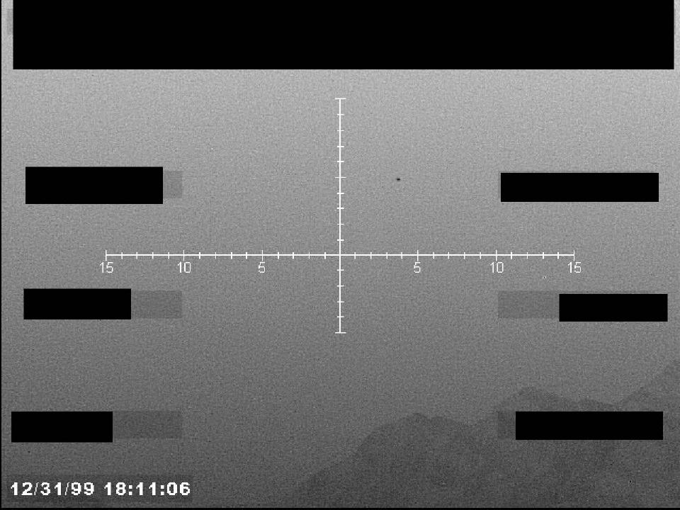 Redacted sensor image with a targeting reticle.