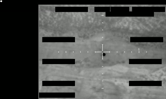 Redacted sensor image with a crosshair targeting an object.