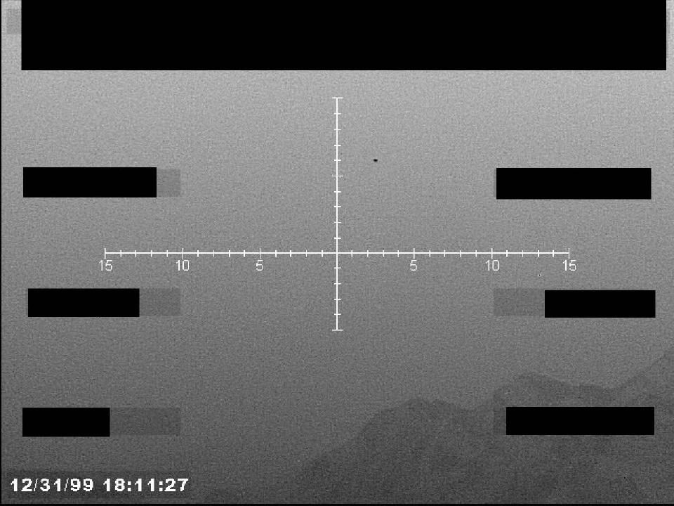 Redacted sensor image with a targeting reticle.