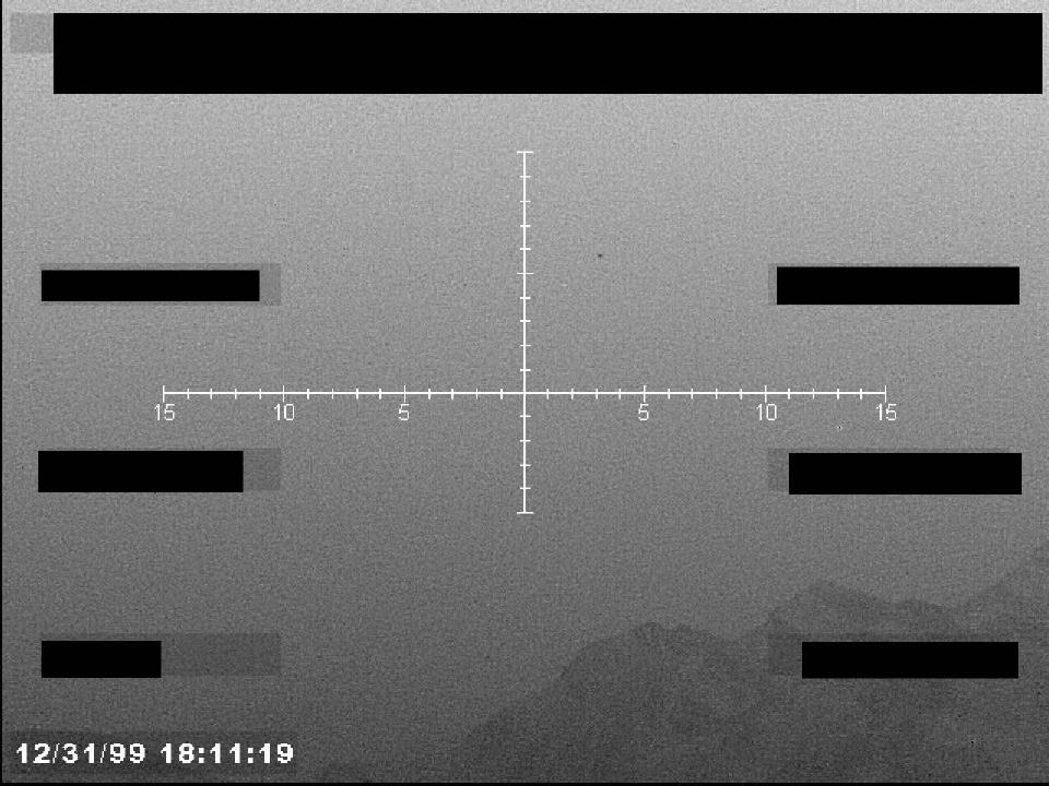 Redacted sensor image with a targeting reticle.