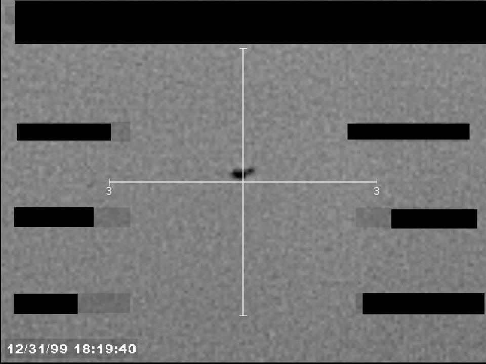 Redacted sensor image with a targeting reticle centered on an object.