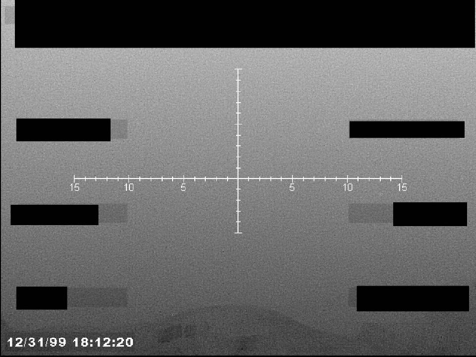 Redacted sensor image with a targeting reticle.