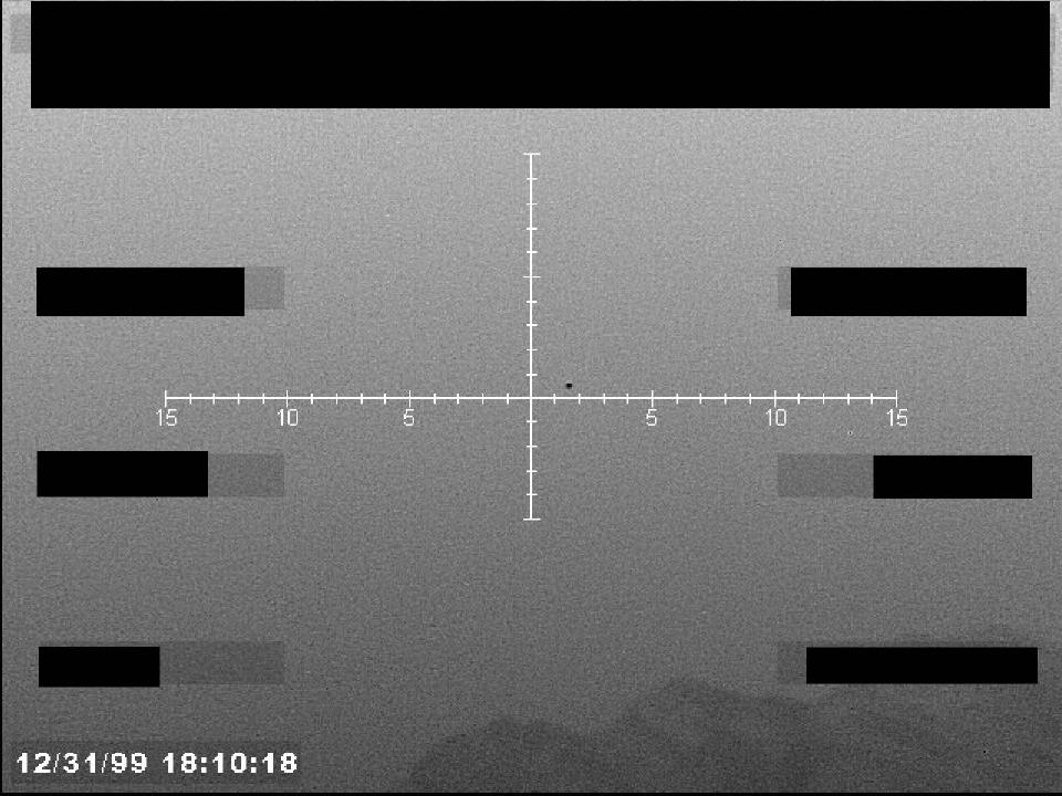 Redacted sensor image with a targeting reticle.